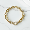 Gold chain bracelet on a marble surface