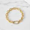 Gold chain bracelet on a marble surface