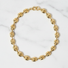 Gold chain bracelet on a marble surface