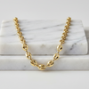 Gold chain necklace on a marble surface