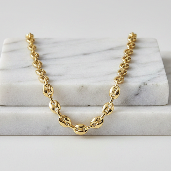 Gold chain necklace on a marble surface
