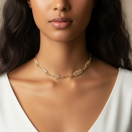 Woman wearing a gold necklace with a neutral background
