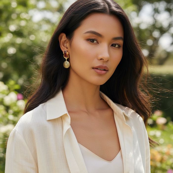 Woman wearing a light-colored blouse with a blurred natural background