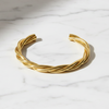 Gold bracelet on a marble surface