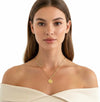Woman wearing a gold necklace on a white background