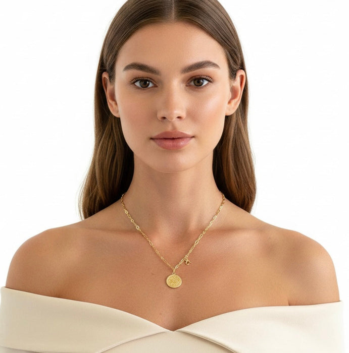 Woman wearing a gold necklace on a white background