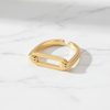 Gold bracelet on a light gray background