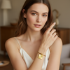 Woman wearing a gold bracelet in an indoor setting