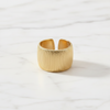 Gold ring on a white marble surface