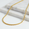 Gold chain necklace on a marble surface