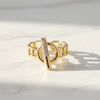 Gold ring with a unique design on a light background