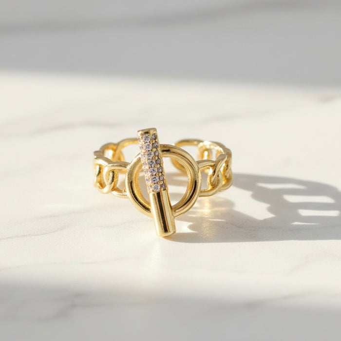 Gold ring with a unique design on a light background