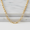 Gold chain necklace on a marble surface
