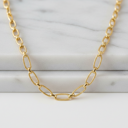 Gold chain necklace on a marble surface