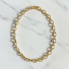 Gold chain necklace on a marble surface