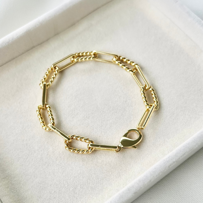 Gold bracelet on a white jewelry box