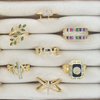 Collection of rings displayed on a wooden stand with a neutral background