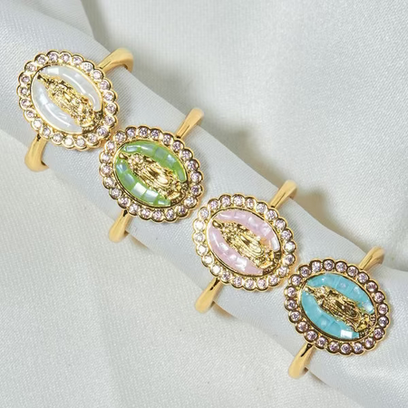 Set of four gold-framed earrings with colorful central stones on a white background