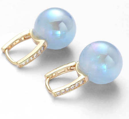 Pearl earrings with gold accents on a white background, featuring 'The Christy F Collection' branding.